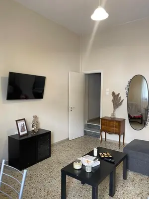 a living room with a couch and a table at The Athenian Filo by Mountain Hotels in Athens
