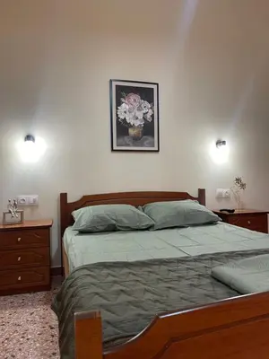 a bedroom with a bed and a picture of flowers on the wall at The Athenian Filo by Mountain Hotels in Athens