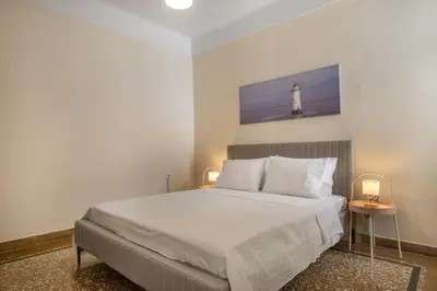 a bedroom with a bed with a lighthouse on the wall at Grand Haven - New Renovated Spacious Apts in Prime Location in Athens