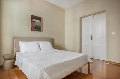a bedroom with a white bed and a white door at Grand Haven - New Renovated Spacious Apts in Prime Location in Athens