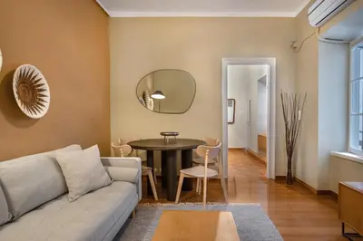 a living room with a couch and a table at Grand Haven - New Renovated Spacious Apts in Prime Location in Athens
