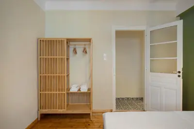 a bedroom with a closet with a bed and a door at Grand Haven - New Renovated Spacious Apts in Prime Location in Athens