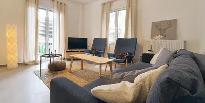 a living room with a couch and chairs and a tv at Condo, Hilton & Caravel area, Athens Center in Athens