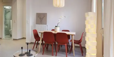 a dining room with a table and red chairs at Condo, Hilton & Caravel area, Athens Center in Athens