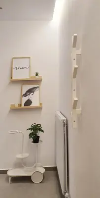 a bathroom with a toilet and a plant on the wall at Condo, Hilton & Caravel area, Athens Center in Athens