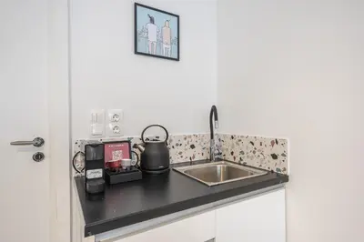 a kitchen counter with a sink and a tea kettle at Zen Rhea - Urban Spacious Loft in Athens Center in Athens