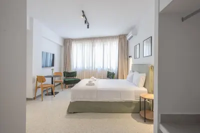 a hotel room with a bed and a table at Zen Rhea - Urban Spacious Loft in Athens Center in Athens