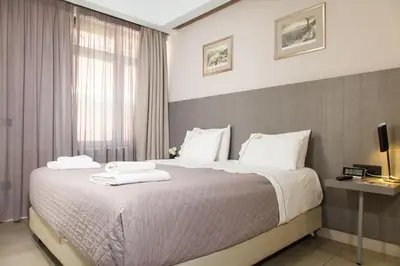 a bedroom with a large bed with white pillows at Hotiday Athens Acropolis in Athens