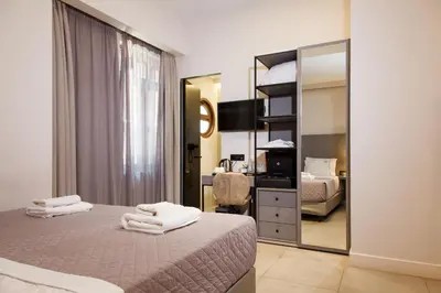 a hotel room with a bed and a mirror at Hotiday Athens Acropolis in Athens