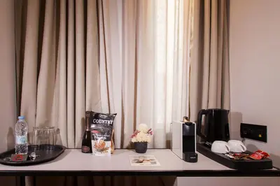 a table with a coffee maker and a microwave at Hotiday Athens Acropolis in Athens