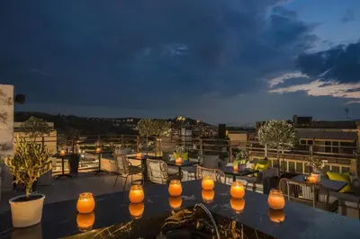 a balcony with a table with candles on it at Hotiday Athens Acropolis in Athens
