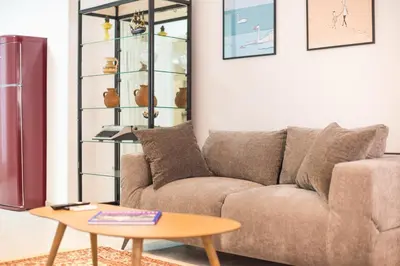 a living room with a couch and a coffee table at Spacious Apartment With Private Garden - Zen Demeter in Athens