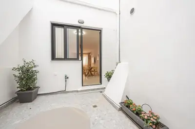 an open door of a white building with plants at Spacious Apartment With Private Garden - Zen Demeter in Athens