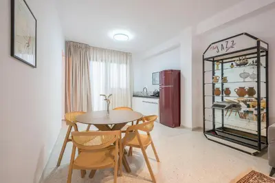 a kitchen and dining room with a table and chairs at Spacious Apartment With Private Garden - Zen Demeter in Athens
