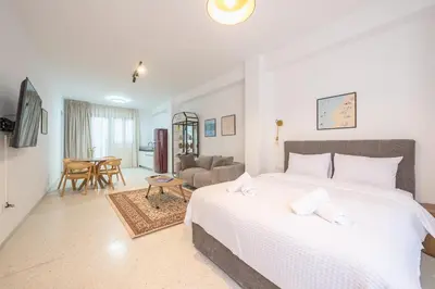 a bedroom with a bed and a living room at Spacious Apartment With Private Garden - Zen Demeter in Athens