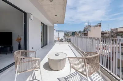a balcony with two chairs and a table at The HostMaster WiseView Panorama in Athens