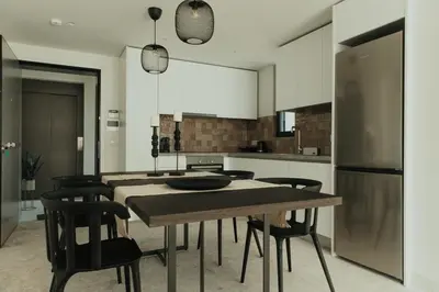 a kitchen with a table and chairs and a refrigerator at The HostMaster WiseView Panorama in Athens