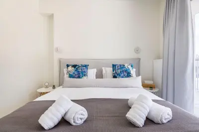 a bedroom with a bed with towels on it at The HostMaster WiseView Panorama in Athens