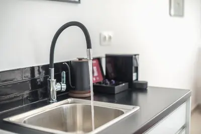 a kitchen sink with a faucet on a counter at Urban Couples Retreat With Rooftop Access - Zen Selene By Tessera in Athens