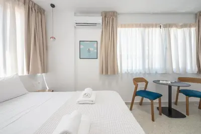 a bedroom with a bed and a table and chairs at Urban Couples Retreat With Rooftop Access - Zen Selene By Tessera in Athens