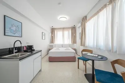 a room with a bed and a kitchen and a sink at Urban Couples Retreat With Rooftop Access - Zen Selene By Tessera in Athens