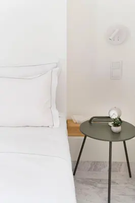 a bedroom with a bed and a table at The HostMaster WiseView Celeste in Athens