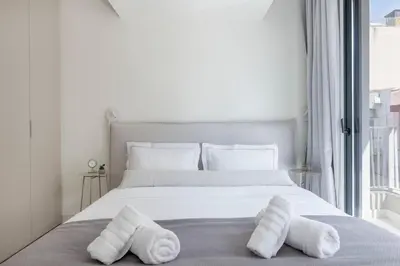 a bedroom with a bed with towels on it at The HostMaster WiseView Celeste in Athens