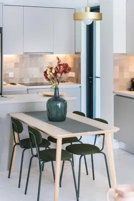 a table with a vase on it in a kitchen at The HostMaster WiseView Celeste in Athens