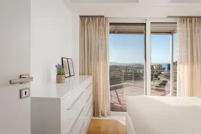 a white kitchen with a view of a balcony at Ellinikon 360 Roof Top in Athens