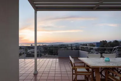 a patio with a table and chairs on a balcony at Ellinikon 360 Roof Top in Athens