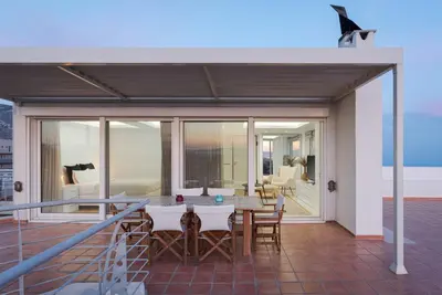 a patio with a table and chairs on a balcony at Ellinikon 360 Roof Top in Athens