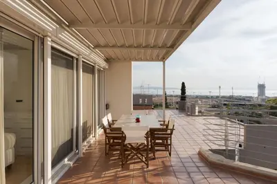 a patio with a table and chairs on a balcony at Ellinikon 360 Roof Top in Athens