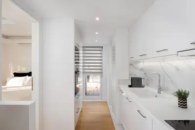 a white kitchen with a sink and a mirror at Ellinikon 360 Roof Top in Athens