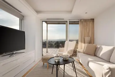 a living room with a couch and a tv at Ellinikon 360 Roof Top in Athens