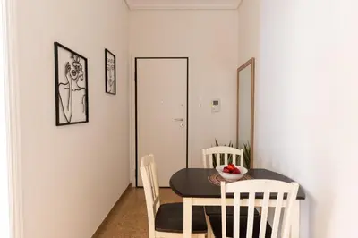 a dining room with a table and chairs at Cozy Nest in Athens