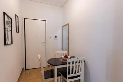 a dining room with a table and two chairs at Cozy Nest in Athens