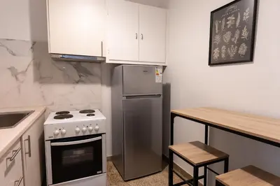 a kitchen with a stove and a refrigerator at Cozy Nest in Athens