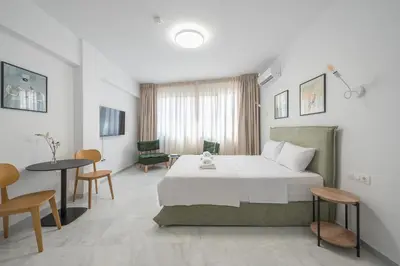 a bedroom with a bed and a table and chairs at Spacious Designed Studio City Center - Zen Metis By Tessera in Athens