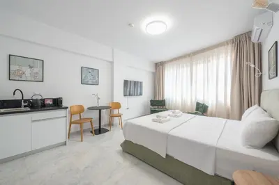 a hotel room with a bed and a kitchen at Spacious Designed Studio City Center - Zen Metis By Tessera in Athens
