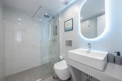 a white bathroom with a sink and a shower at Spacious Designed Studio City Center - Zen Metis By Tessera in Athens