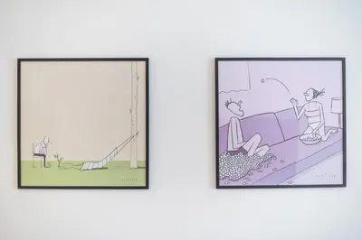 two framed illustrations of people on a slide at Bright & Airy Family Studio with Rooftop Access - Zen Theia by Tessera in Athens