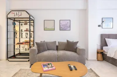 a living room with a couch and a table at Bright & Airy Family Studio with Rooftop Access - Zen Theia by Tessera in Athens