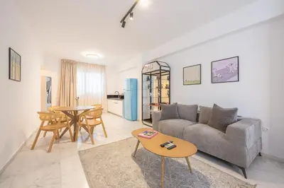 a living room with a couch and a table at Bright & Airy Family Studio with Rooftop Access - Zen Theia by Tessera in Athens