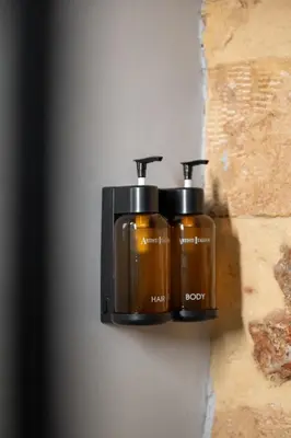 a wall mounted soap dispenser on a wall at Unique & Stylish Living in Kipseli in Athens