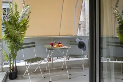 a table and chairs in a room with plants at Unique & Stylish Living in Kipseli in Athens
