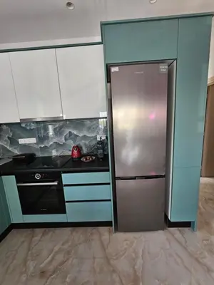 a kitchen with a stainless steel refrigerator and cabinets at Keti's Elite in Athens