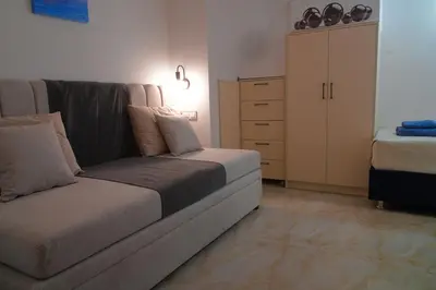 a living room with a couch and a dresser at Keti's Elite in Athens