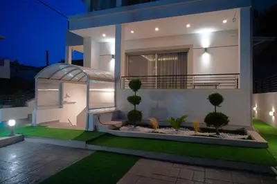 a villa with a garden at night at Keti's Elite in Athens