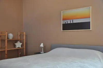 a bedroom with a bed and a picture on the wall at The BloomYard in Markopoulo