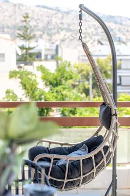 a hanging swing on a balcony with a view at Glyfada Aelia Prestige in Athens